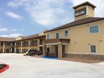 Exterior of hotel showing parking area and entrance