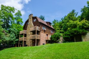 Rear of condo showing wooden decks, trees and grassy area