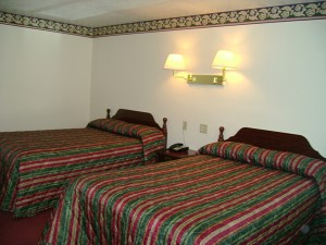 two double beds, night stnad with telephone, wall mounted bedside lights and carpet flooring