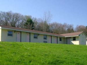 Entrance to rooms overlooking grassy area and surrounded by trees