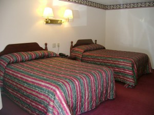 two double beds, night stand with telephone, wall mounted bedside lights and carpet flooring