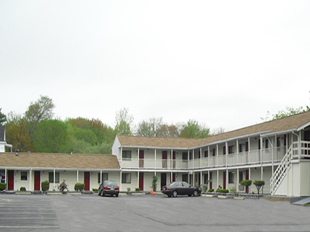 PMAME Outside room entrances, parking area with plants and bushes in planters