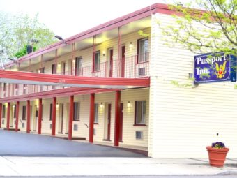 Two sory building with exterior walkways, parking spaces