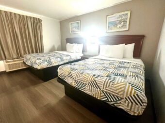 Two double beds, night stand, art images, laminate flooring
