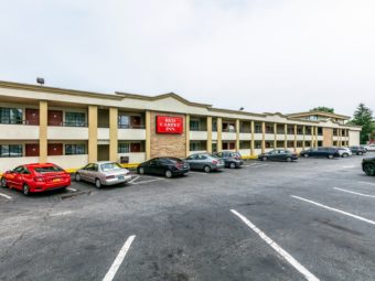 Two storey building with exterior walk ways and parking area