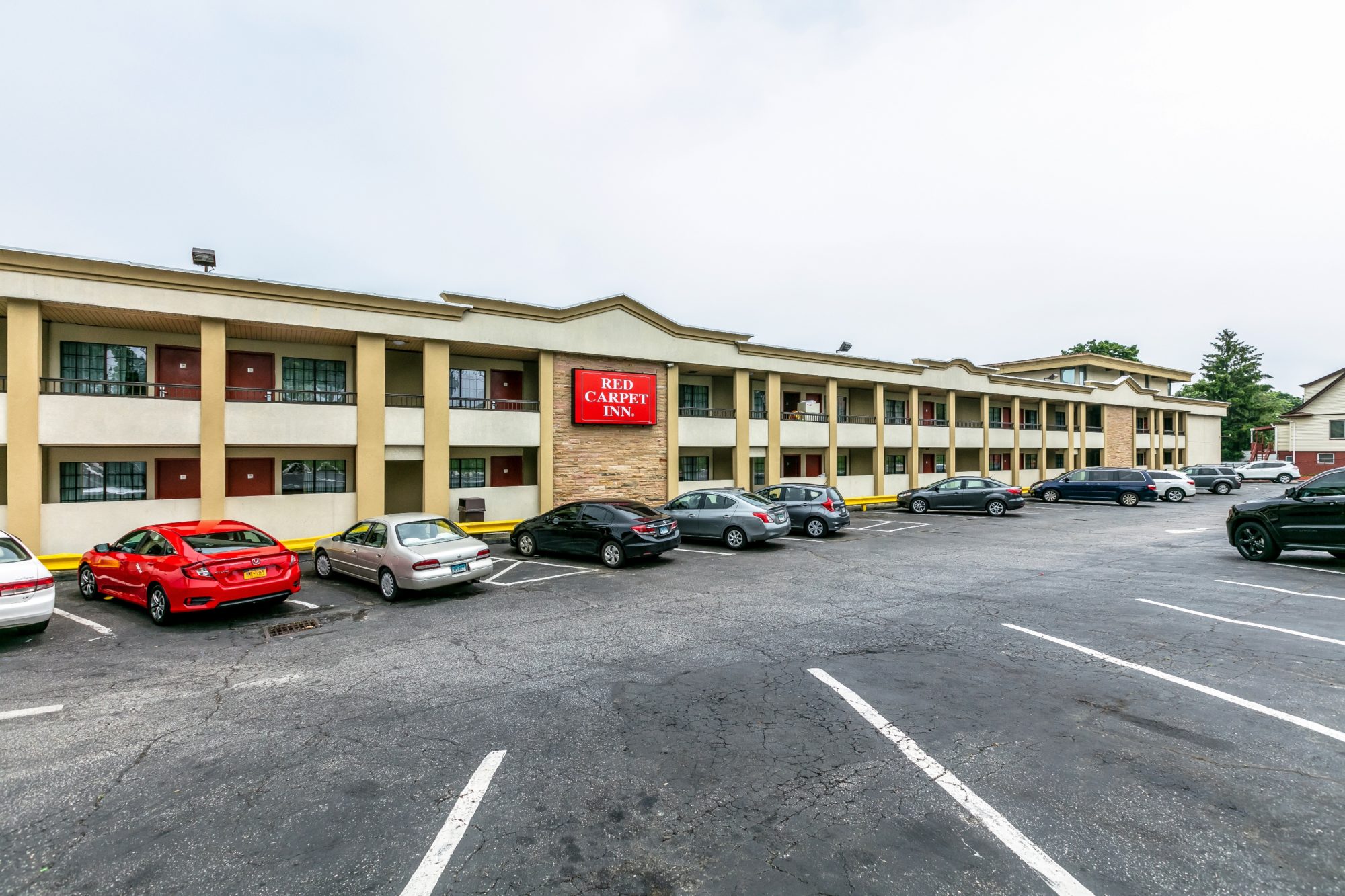 Two storey building with exterior walk ways and parking area