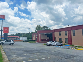 Brand signage, hotel entrance, parking spaces