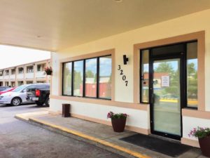 Hotel entrance, potted flowering plants, canopy