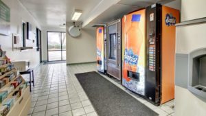 Vending snack machines, guest information leaflet stand, small table with microwave, tiled flooring