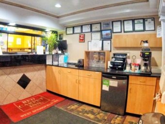 Guest check in desk, breakfast counter display with toaster, cereal dispensers and coffee machine