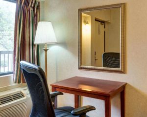 Floor lamp, small desk with office chair, mirror