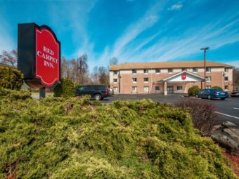 Exterior showing signage, landscaping, front entrance and parking lot