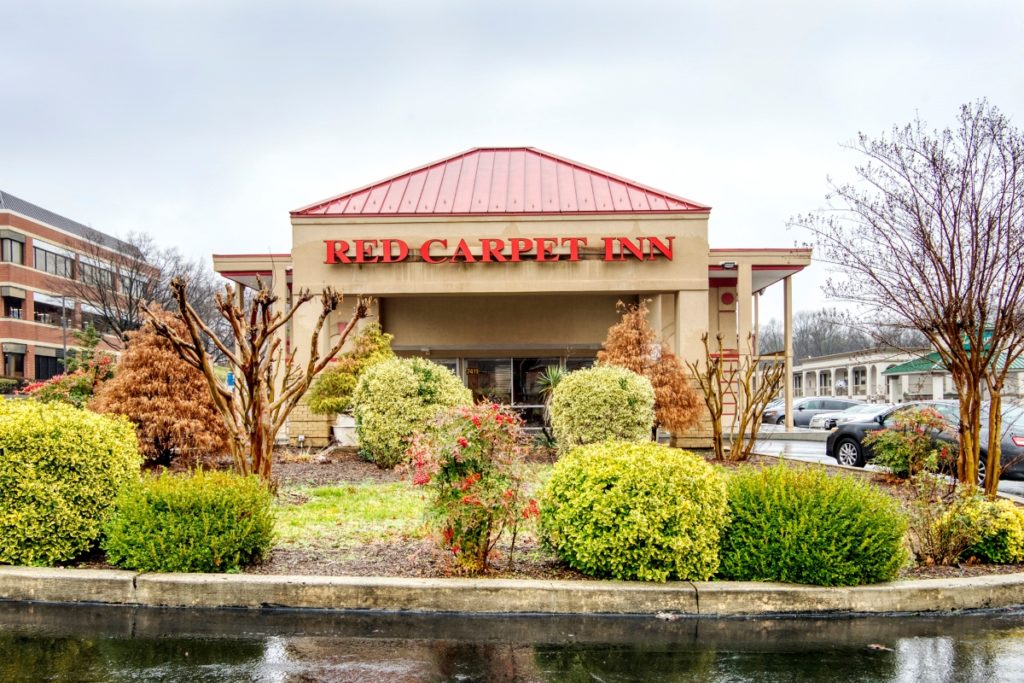 Hotel Entrance, landscaped area with small trees and bushes