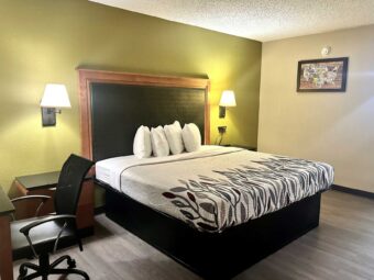 King bed, night stands, bedside wall lights, desk with chair, laminate flooring