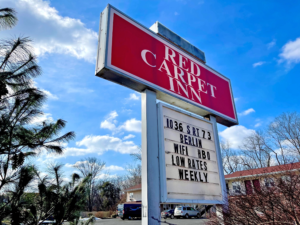 Brand signage with hotel in background