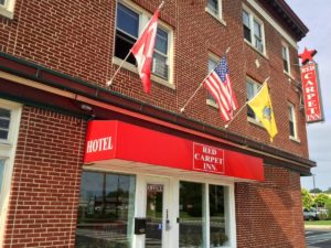 Hotel entrance, wall mounted flags, hotel brand signage