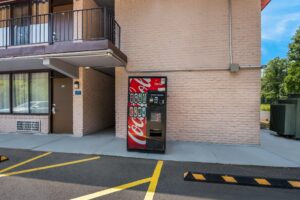 Coke vending machine next to guest room exterior entrances