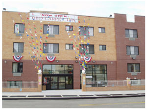 Hotel street entrance, three story hotel building surrounded by fencing