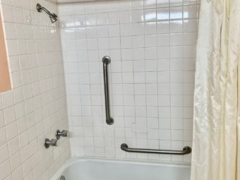 Shower tub with grab handles and shower curtain