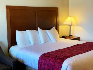 King bed, sofa, night stand with bedside lamp and clock
