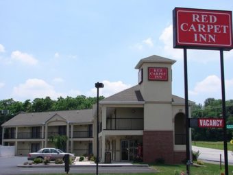 Exterior of hotel showing entrance and parking lot