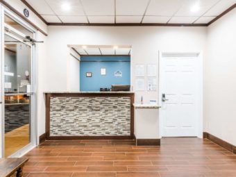 Guest check in desk, door to breakfast area, tiled flooring