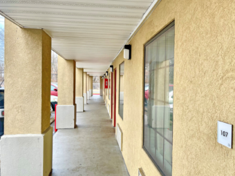 Exterior room entrances, covered walkway, parking spaces