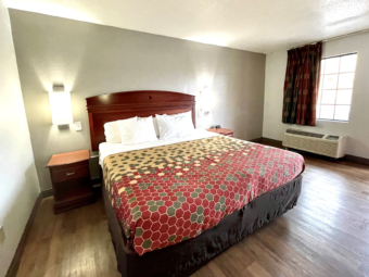 king bed, night stands, bedise wall lights, laminate flooring