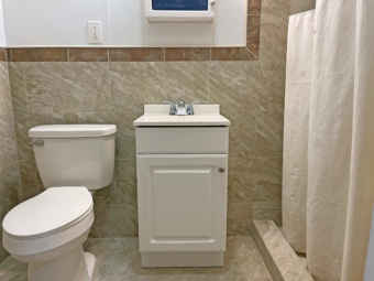 Vanity unit, toilet, tiled walls