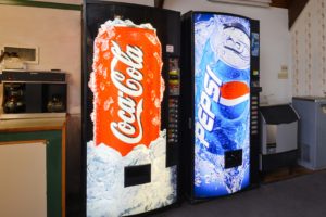Soda vending machines, ice dispenser, coffee pots on breakfast counter