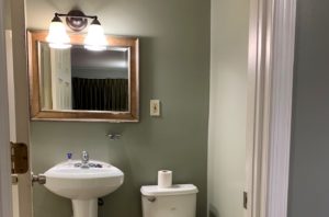Mirror with overhead lights, sink, toilet