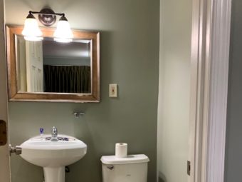 Mirror with overhead lights, sink, toilet