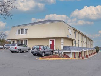 Rear of hotel, three story building, parking spaces