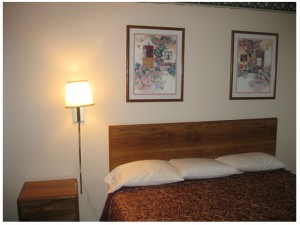 King bed, night stand, wall mounted bedside light and art