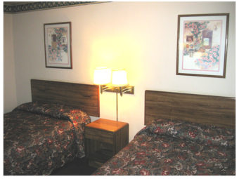 Two double beds, night stand, wall mounted bedside lights and art