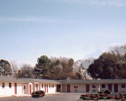 One story building with exterior room entrances and parking spaces