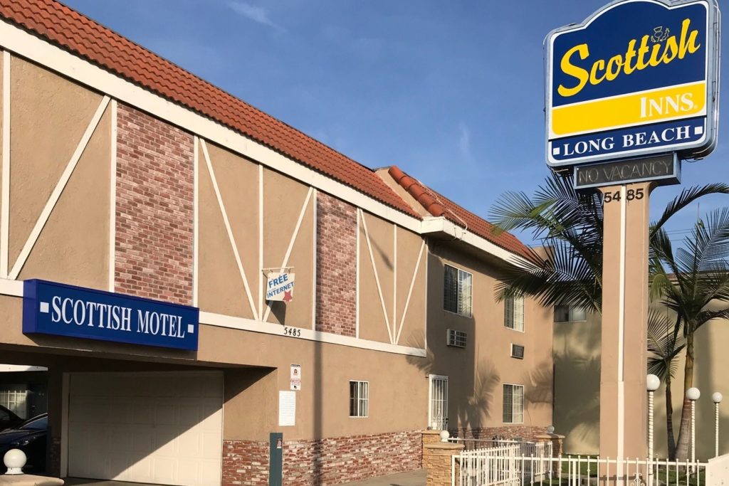 Hotel exterior and drive through entrance, brand signage