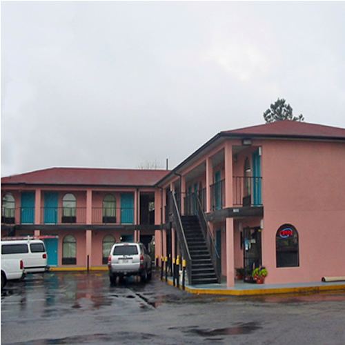 SGAAJ Exterior 1 Two story building, hotel entrance, exterior room entrances, walkeays and stairways, parking spaces