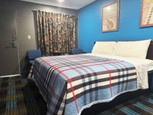 king bed, small table and chairs, art images, carpet flooring