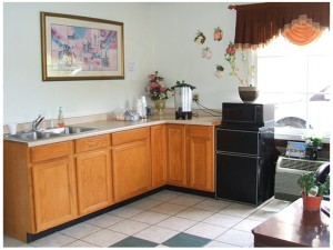 Breakfast counter display with coffee machine, fridge, microwave and tiled flooring