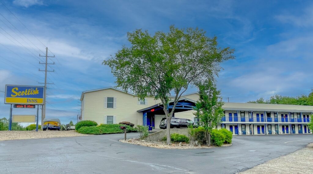 Brand signage, canopied drive through hotel entrance, two story building with covered walkways and exterior guest room entrances