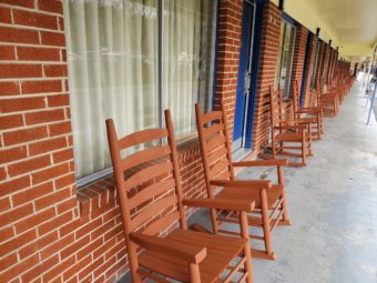 Exterior guest room entrances with rocking chairs