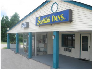 Hotel entrance, porch, trees in background