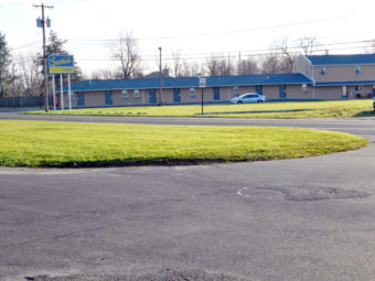 Brand signage, one story building, grassy areas