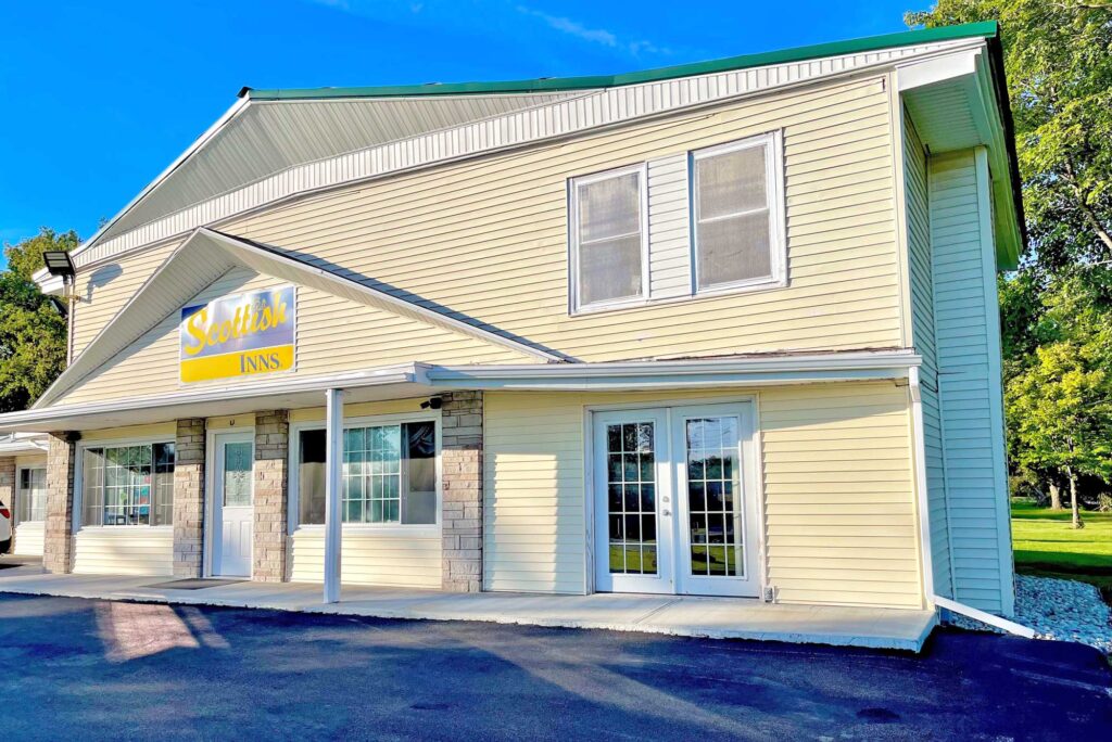 Hotel entrance, two story building, brand signage