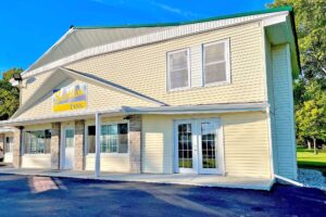 Hotel entrance, two story building, brand signage