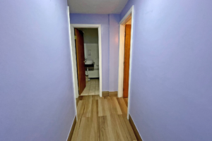 Hotel interior corridor showing doorways to guest rooms and bathroom