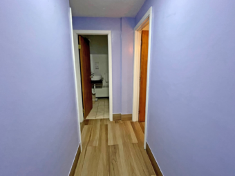 Hotel interior corridor showing doorways to guest rooms and bathroom