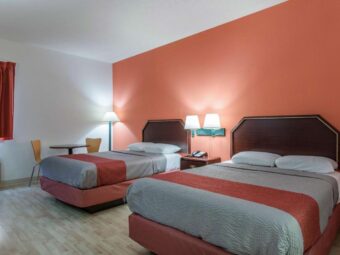 Two double beds, table and chairs, floor lamp, bedside wall lights, night stand with telephone, laminate flooring