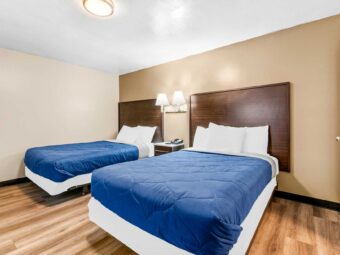 Two double beds, night stand with telephone, wall bedside lamps, laminate flooring
